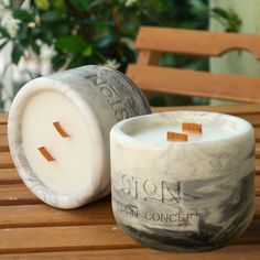 a white candle sitting on top of a wooden table