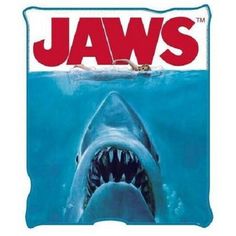 a shark with its mouth open in front of the words jaws on it's side