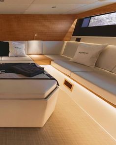 a bed sitting inside of a bedroom on top of a wooden floor next to a window