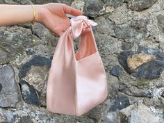 🔘 This Elegant Satin knot bag is ideal for the wedding day, night out, party, special occasion, brides, bridesmaids, mothers of the bride, or any formal fun 🔘 This  bag has an elastic opening and a stiff bottom   🔘 Please contact us for a custom order. 🔘 Material: Satin fabric or faux Silk. The lining fabric is the same fabric as on the outside. This bag has a magnetic snap closure inside. It also has a bottom shaper inside. 🔘 Measurements: Bottom Length x Height x Depth; 16 x 16 x 10 cm / Formal Purse Evening Bags, Satin Pouch Bag, Elegant Wedding Bags With Bow Detail, Elegant Wedding Bags With Bow, Elegant Shoulder Bag With Bow As A Gift, Chic Wedding Bag With Bow, Chic Wedding Bags With Bow Detail, Chic Wedding Bags With Bow, Chic Handheld Evening Bag For Wedding Guest