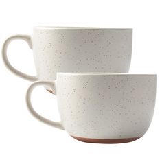 two white coffee cups with brown rims