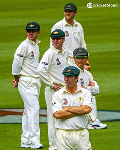 the australian cricket team is standing on the field with their arms crossed and looking at the camera