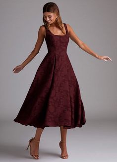 a woman in a dress with her arms out and one hand extended up to the side