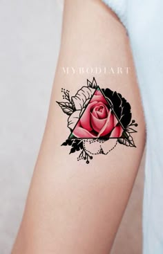 a woman's arm with a pink rose tattoo on the left side of her arm