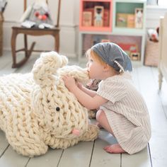 a small child is playing with a stuffed animal