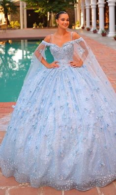 Long pastel off the shoulder quinceanera ball gown with 3D floral details and sheer cape sleeves. Sweet 15 Dresses Quinceanera Light Blue, Baby Blue Quince Dresses, Light Blue Sparkly Dress, Butterfly Quince Dress, Sweet 15 Dresses Quinceanera, Baby Blue Quinceanera Dresses, Butterfly Quinceanera Theme, Blue Quince Dress, Cinderella Quince