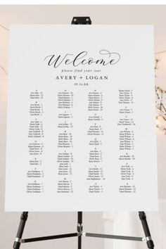 a sign that says welcome with the names and dates on it, sitting in front of a