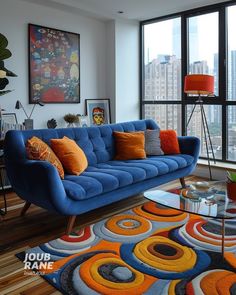 a living room with a blue couch and colorful rug in front of large windows overlooking the city