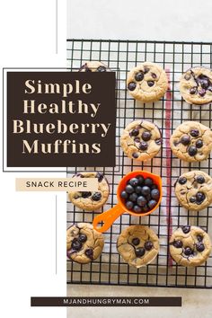 blueberry muffins on a cooling rack with an orange spoon next to them