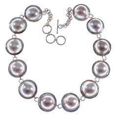 "12 Mabe Blister Pearl Chain 925 Sterling Silver Choker Necklace Mabe pearl strand necklace made with 12 stunning mabe pearls. Gorgeous pearls, excellent luster and large size. Excellent workmanship. A stunning pearl necklace that will catch plenty of compliments! Necklace Length: 15 1/2\"-16 1/2\", adjustable Pearl Size: ~14mm in 20mm shell Pendant Material: 925 sterling silver Pearl Type: Mabe blister pearl Pendant Weight: ~2.4oz" Silver Pearl Necklace With Pearl Charm, Silver Round Pearl Necklace, Silver Pearl Chain Bracelet, Silver Single Strand Pearl Bracelet, Silver Pearl Chain Necklace, Silver Chain Anklet, Sterling Silver Choker Necklace, Pearl Strands Necklace, Sterling Silver Choker