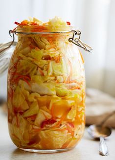 a glass jar filled with food sitting on top of a table