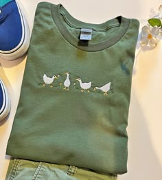 a pair of shoes and a t - shirt with ducks on them