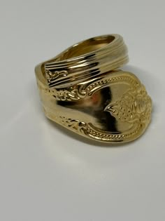 a gold ring sitting on top of a white table