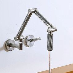 the faucet is attached to the wall with two handles, and has an angled design