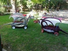 two children's buggies sitting in the grass