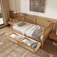 a bed with two drawers underneath it in a living room next to a large window