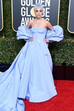 lady in blue at the golden globe awards wearing an off - shoulder gown with puffy sleeves