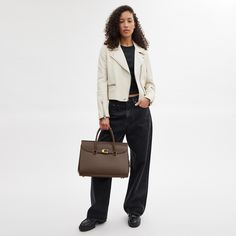 Our Broome has all the effortless cool of its namesake Soho street. The spacious foldover silhouette is crafted of luxe refined leather with a high shine finish and secures with our pushlock “C” closure. Featuring pockets inside and out for easy organization and room for a 16” laptop carry it by hand or use the detachable strap to wear it crossbody. | Coach Broome Carryall Bag 36 - Women's - Brass/dark Stone Soho Street, Crossbody Coach, Easy Organization, Carry All Bag, Coach Bag, Tote Handbags, Soho, Inside Pocket, Women Handbags