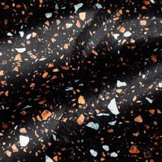 black and orange speckled fabric with white dots