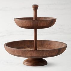 three tiered wooden tray on marble counter top