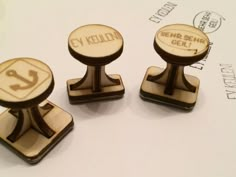 three wooden stamps with numbers on them sitting next to each other