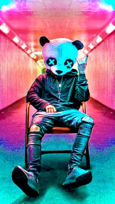 a panda bear sitting on top of a chair in a room with red and blue lights