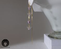 Elegant two floors threader earrings with delicate hand folded lavender origami cranes.  Small and light cranes to match the dangling thread design. The cranes are so light, you will hardly notice wearing them.  Earring thread is 14 cm.  The approximately size of crane is 1.3cm (0.5") wing span. The cranes are lacquered many times and will withstand for instance rain.  Although this is made of paper, it's fairly solid. Earring thread hooks are 18K gold on 925 sterling silver base. Lavender Origami, Gold Thread Earrings, Grape Earrings, Constellation Jewelry, Origami Cranes, Thread Design, Bottle Earrings, Minimal Earrings, Origami Crane