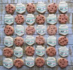 cookies decorated with face and mouth shapes on a blue wooden surface, including one cookie in the shape of a mask