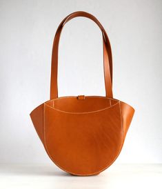 Tote bag in original design, for your everyday use, from Tuscan vegetable tanned leather Vera Pelle. It can be carried in the hand or on the shoulder. *Material: genuine Italian leather of vegetable tanning, Italian fittings. *Color: tan. Dimensions: 12.6”(2cm) x 9.4”(24cm) x 4.7”(12cm), (under the handle 10”(26cm). *Inside: one compartment, one accessory pocket. The bag closes with a holster button. *100% Handmade. *Bag stitched by hands saddle seam - most reliable and strong seam. Edges polish Funky Handbags, Tote Leather Bag, Wood Bark, Inside Bag, Handbag Handles, Handmade Bag, Womens Tote, Vegetable Tanned Leather, Tanning