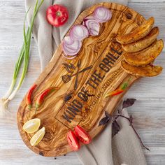 a wooden cutting board topped with sliced up vegetables