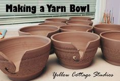 many clay bowls sitting on top of a counter next to a window with the words making a yarn bowl