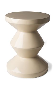 a white table with three stacked pedestals on the top and bottom, in front of a white background