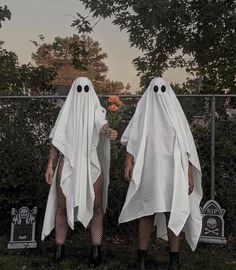 two people in ghost costumes standing next to each other