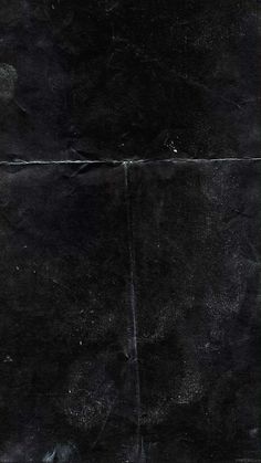 an old black leather textured background with scratches and fading paint on the bottom part of it