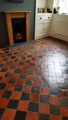 a living room with a fireplace and tiled floor