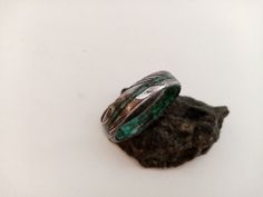 "Dark green Emerald, Malachite stone, For women, For men, Gift for her, gift for him, Gift for boyfriend, Stone ring, Raw stone rings, Unisex. The ring in the photo is 5mm width. This can be customized. This is an exclusive model of Woodlife Jewelry. Damascus steel band, beveled edges, mix Malachite stone and Dark green Emerald stone inside and a 1 mm outer line with stone. Customize your ring by choosing the birthstone: January - Garnet February - Amethyst March - Aquamarine, Bloostone April - Handmade Green Emerald Ring, Nature-inspired, Handmade Nature-inspired Green Emerald Ring, Handmade Green Emerald Rings, Handmade Emerald Green Rings, Handmade Adjustable Emerald Ring, Handmade Emerald Rings, Handmade Nature-inspired Emerald Ring For Anniversary, Adjustable Green Turquoise Ring As Gift, Adjustable Green Turquoise Ring Gift