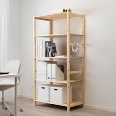 an office shelving unit with white storage bins