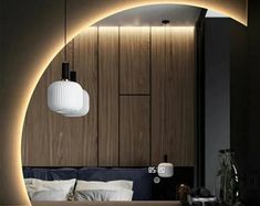 a bed sitting under a light next to a wooden headboard in a living room