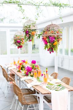 a table with flowers hanging from the ceiling