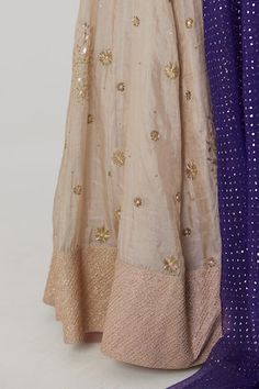 Gold banarasi silk tissue kalidar lehenga with bahar embroidery using sequin, aari and zardozi highlights. Paired with a purple half sleeves chevron fleur woven banarasi silk brocade blouse and blue-purple ombre mukaish embroidered organza dupatta. - Aza Fashions Designer Raw Silk Sharara With Gota Work, Pre-draped Tussar Silk Saree With Zari Work For Reception, Tussar Silk Pre-draped Saree With Zari Work For Reception, Designer Tissue Silk Anarkali Set With Cutdana, Designer Anarkali Set With Cutdana In Tissue Silk, Chanderi Sharara With Dori Work For Reception, Unstitched Tissue Silk Anarkali Set For Navratri, Chanderi Anarkali Saree Set For Reception, Navratri Tissue Silk Sharara With Resham Embroidery