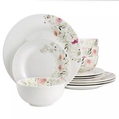 a set of white dishes with flowers on them