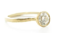 One of our best selling rings, this diamond solitaire is a classic, but never gets old. Sculpted to perfection in 18k gold, this classic looks like it could be centuries old. Inspired by the Etruscan era where metalsmithing was of mastery and the craftsman's hand always seen. Stack this gorgeous ring for a dramatic look. This 18k gold sculpted, hammered, and tapered ring features a round brilliant cut diamond accented with a single milgrain bezel. Pictured in:18k yellow gold1.11 ct white diamond Classic 14k Gold Round Wedding Ring, Timeless Round Single Diamond Wedding Ring, Yellow Gold Diamond Ring With Single Cut Round Stone, Timeless Rings With Classic Cut Single Diamonds, Timeless Diamond Ring With Single Cut, Timeless Diamond Ring With Single Cut Diamonds, Timeless Classic Cut Diamond Ring With Single Cut Diamonds, Timeless Round Ring With Single Diamond, Timeless Single Diamond Ring