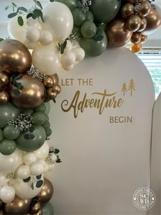 balloons and greenery decorate the entrance to an adventure begins event