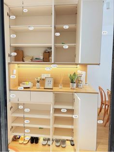 an open cabinet with lots of shelves and drawers