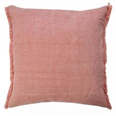 a pink pillow with fringes on the front and back of it, against a white background