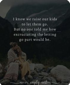 a woman sitting on top of a pile of rocks next to a mountain with a quote