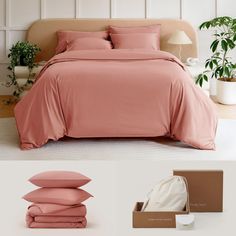 a bed with pink sheets and pillows next to a brown box filled with white pillows