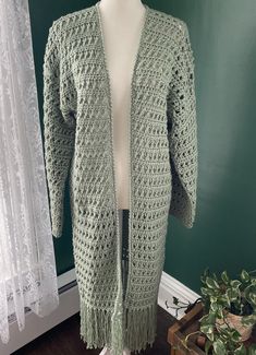 Crochet duster cardigan in Sage green. Medium-Large. Drapey, open stitches with fringe on the bottom gives an airy, boho feel.  Sweater has an open front and is intended to be slightly oversized and hits below the knee. Listed as size medium, but oversized fit can work as size large. Crochet Duster Cardigan, Crochet Duster, Duster Cardigan, Jumpers And Cardigans, Cardigans For Women, Sage Green, Front Open, The Knee, Sweater Outfits