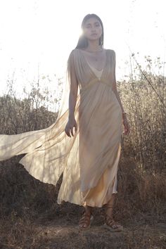 The Jala dress is a modern take on a Grecian inspired romantic feminine style. A beautifully light transparent silk dress that you can get creative layering with your favourite pieces. One Size| AUS 6 - 12 UK 6 - 12 US 2 - 8 EU 34 - 40 Fit | Will drape more on thinner frame Will drape less on fuller frame Paired with | Champagne Rose Slip Note| This fabric varies in shade when in different lights. Dress is transparent. Slip dress is sold separately Care | Please see care label for item specific Elegant Flowy Dress For Wedding Night, Summer Evening Dress With Subtle Sheen, Delicate Sheer Evening Dress, Ethereal Evening Maxi Dress, Elegant Sheer Flowy Maxi Dress, Sheer Flowy Maxi Dress For Wedding, Silk Wedding Dress With Subtle Sheen, Bohemian Evening Dress With Cape Sleeves, Ethereal Style Evening Maxi Dress