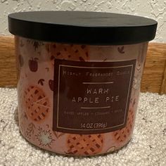 an apple pie jar is sitting on the floor